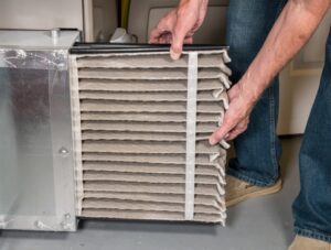 hand-pulling-out-dirty-air-filter